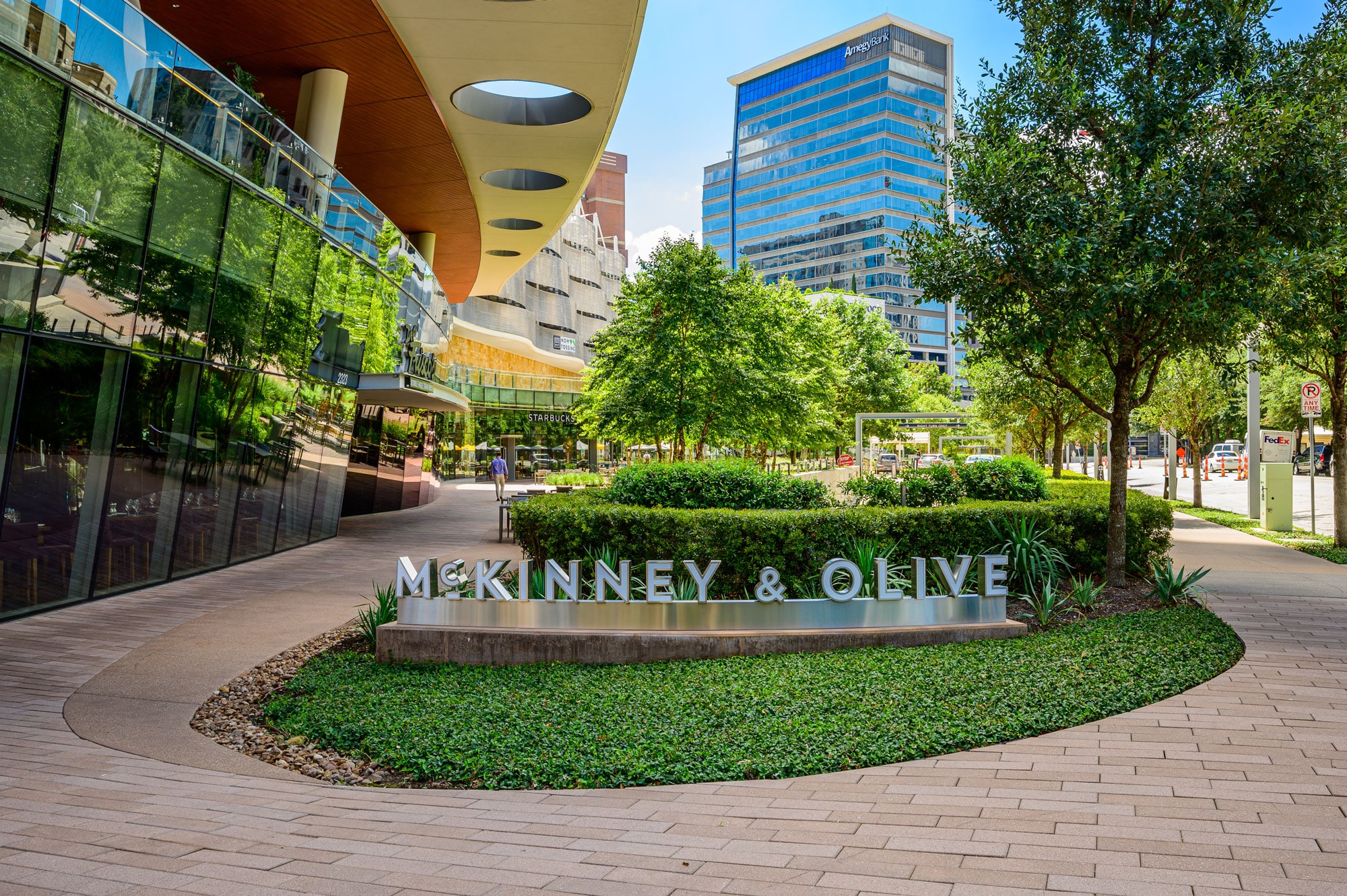 Afternoon photo of McKinney & Olive in downtown Dallas, Texas, with a well-maintained landscape provided by Southern Botanical.