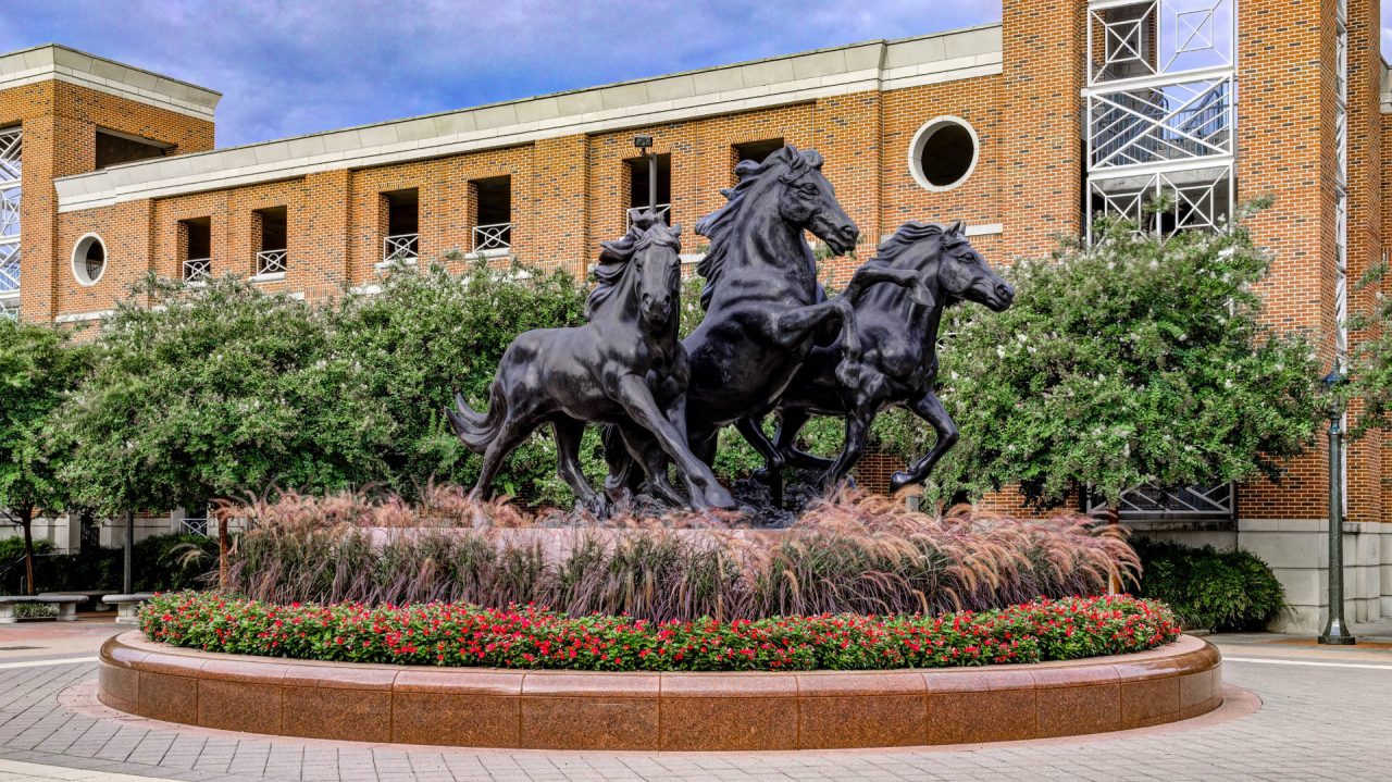 a statue of three horses in front of a building | Southern Botanical
