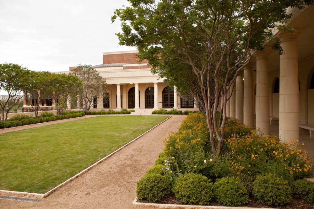 a large building with a lawn and trees in front of it | Southern Botanical
