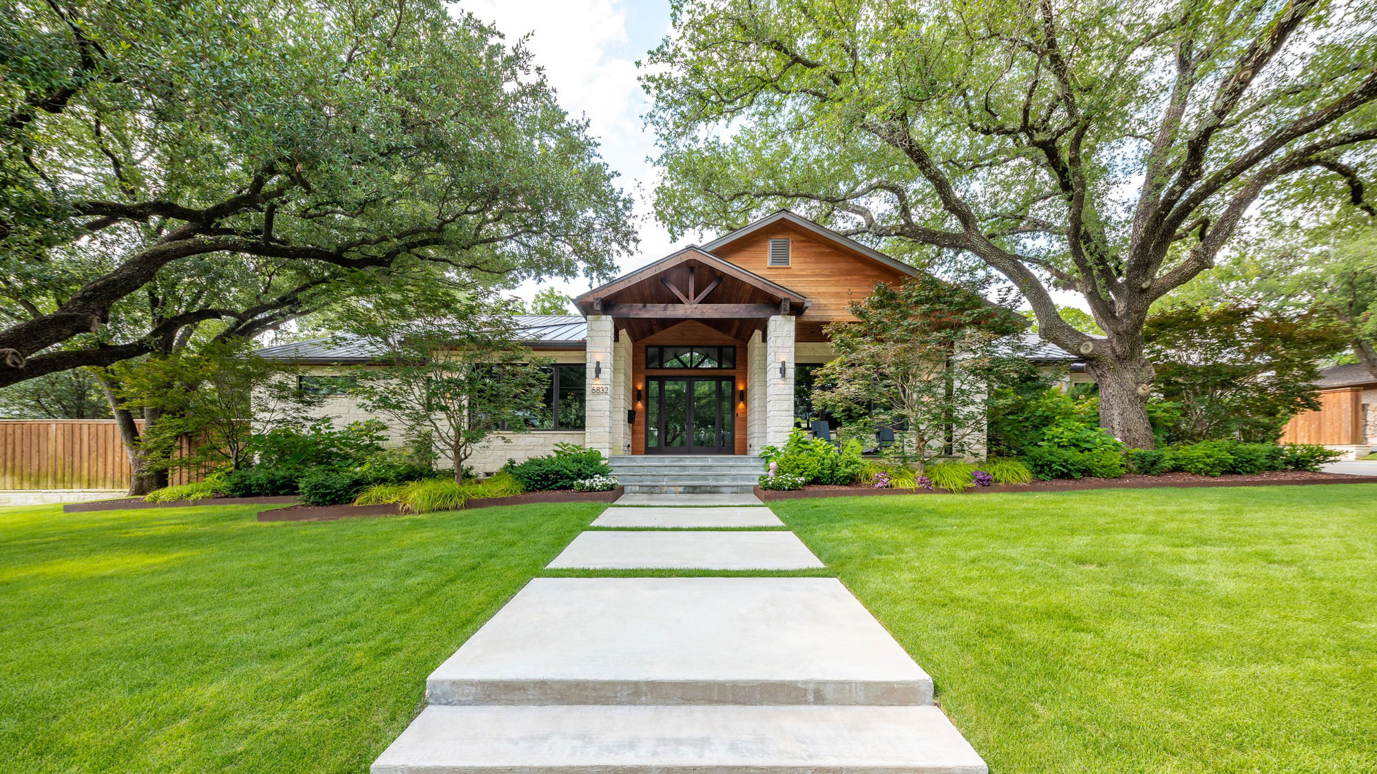 A modern home in Dallas, Texas, with a modern design & well maintained landscape.
