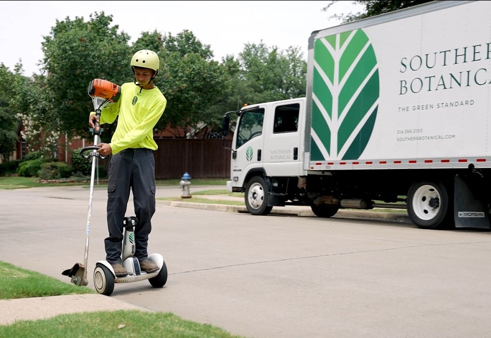 Frontline Crew Member Riding a Segway for Southern Botanical Landscaping Services in Dallas Texas