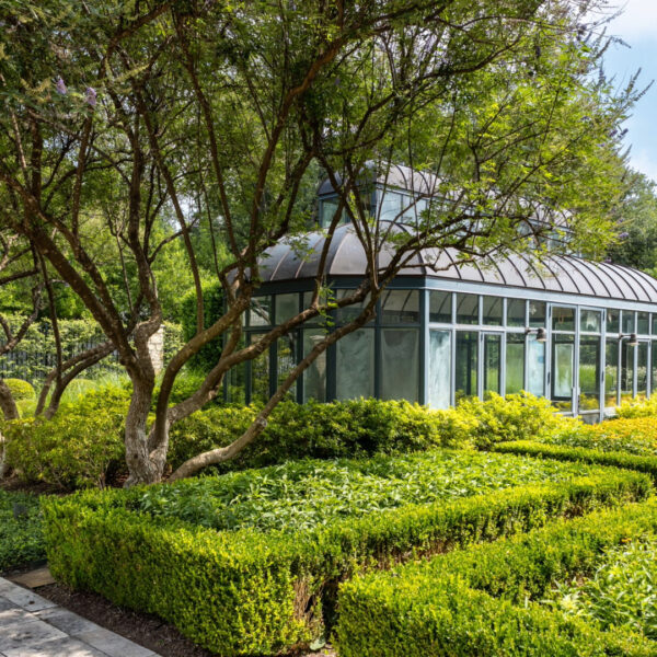 Backyard Greenhouse and English Garden with Perennials maintained by Southern Botanical